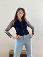 1980s style black velour zip-front track jacket with mesh sleeves closeup