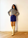 1960s inspired purple miniskirt with boots, front.